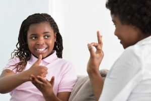 Photo of two people using sign language