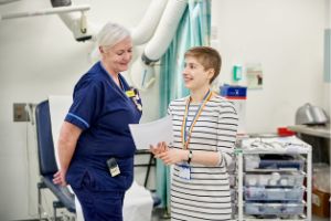 Clinical Librarian talks to Medical Colleague in Library