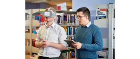 Technology Enhanced Learning Manager and colleague, one person wears virtual reality goggles